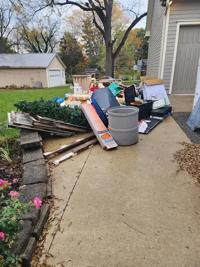 Dumpster being loaded with debris for Roofing Dumpster Rental in Fraser